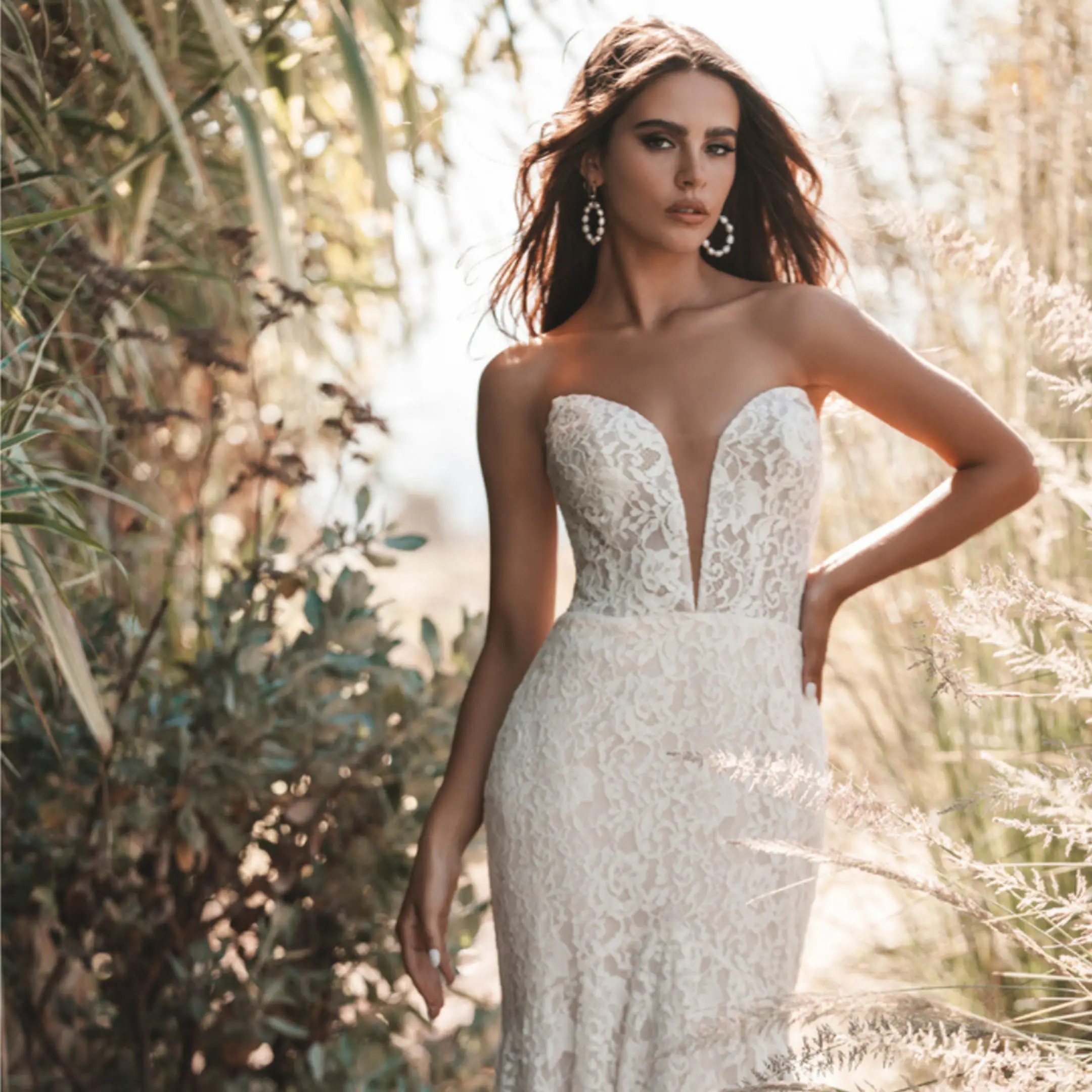 Model wearing strapless lace white wedding dress